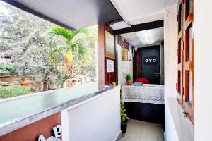 a restaurant with a view of a palm tree from a window at SPOT ON Nagananda Residency in Bengaluru