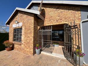 a brick building with a sign on it at 419 Guest House in Midrand