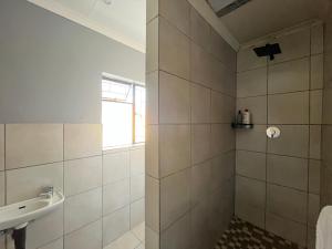 a bathroom with a shower and a sink at 419 Guest House in Midrand +9 photos