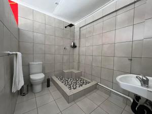 a bathroom with a toilet and a sink at 419 Guest House in Midrand