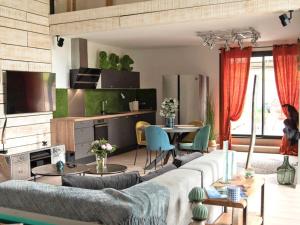 un soggiorno con un divano e un tavolo di Loft cosy avec piscine et spa, à 10 min de Vichy, proche golf et nature - FR-1-489-337 a Cognat-Lyonne