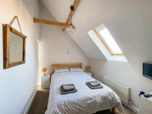a bedroom with a bed with two towels on it at Sea Is All Around in Mundesley
