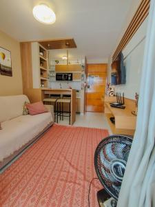 a living room with a couch and a table and a kitchen at Israel Flat Tambaú - 315 in João Pessoa