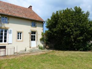 an old house with a tree in front of it at Maison de Campagne avec Jardin Clos, Wi-Fi, Animaux Acceptés et Proche Station Thermale Néris les Bains - FR-1-489-272 in Montvicq