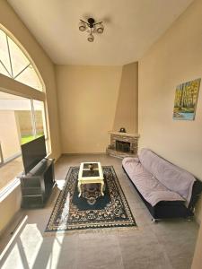 a living room with a couch and a fireplace at House - Quinta Paraíso Mitad del Mundo in San Antonio