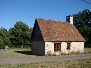 an old stone house on the side of a road at Champsecret : Maison Ancienne avec Poêle, Jardin Clos et Animaux Acceptés - FR-1-497-15 in Champsecret