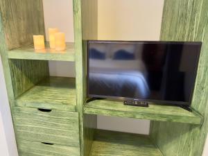 a tv in a wooden book shelf with a tv at Apolonia en ValQuirico in Santeagueda