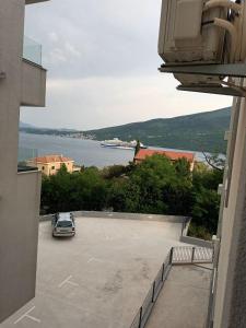a car parked in a parking lot next to the water at Blue Bay Boutique Studio in Đenovići +2 photos