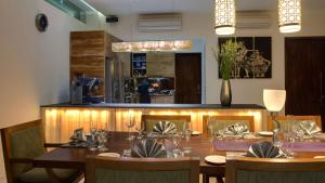 a dining room with a table and chairs and a counter at Villa Aiko in Jimbaran