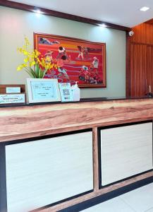 a counter with three windows and a picture on the wall at Joyce Apartelle Mandaluyong in Manila