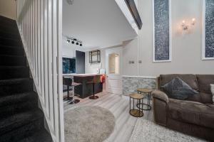 a living room with a couch and a bar at Luxurious Royal 2BR Apartment, Glasgow City Centre in Glasgow