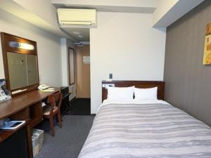 Postel nebo postele na pokoji v ubytování Hotel Route-Inn Utsunomiya Miyukicho -Kokudou4gou-