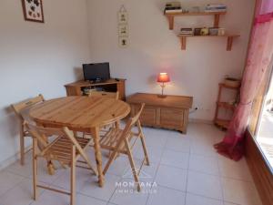 a room with a wooden table and chairs and a desk at Charmant studio avec cabine - 4 pers - St Jean de Sixt - FR-1-458-223 in Saint-Jean-de-Sixt