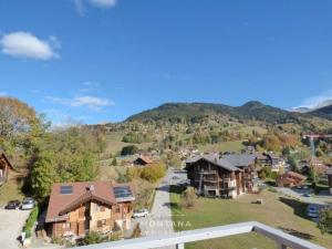 an aerial view of a home in the mountains at Charmant studio avec cabine - 4 pers - St Jean de Sixt - FR-1-458-223 in Saint-Jean-de-Sixt +9 photos