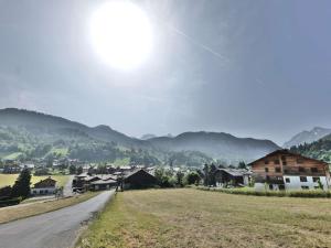 a dirt road in a village with mountains in the background at Charmant studio avec cabine - 4 pers - St Jean de Sixt - FR-1-458-223 in Saint-Jean-de-Sixt +10 photos