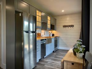 a kitchen with a stainless steel refrigerator at Whitecaps Cabana for Couples in La Have +22 photos