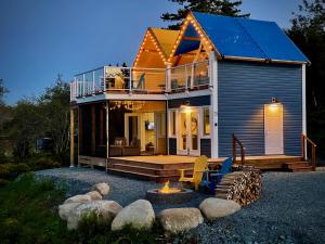a house with a fire place in front of it at Whitecaps Cabana for Couples in La Have