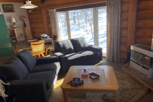 a living room with a couch and a coffee table at Appi Ski Chalet in Hachimantai +11 photos