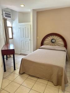 a bedroom with a bed and a table and a door at Casa Caracol in Puerto Vallarta
