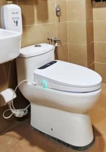 a bathroom with a white toilet and a sink at Guan Gong Hotel Jin Shang Development Jonker Street in Malacca