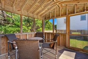 a screened in porch with a table and chairs at 7147 - Geri's Place #11A in Wanchese