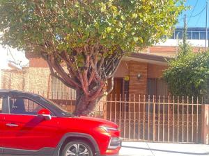 a red car parked in front of a house at nice comfortable house an excellent location, in Aguascalientes