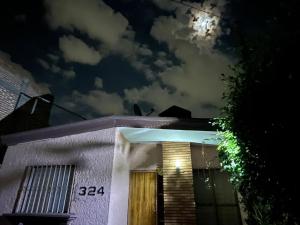 a house at night with the moon in the sky at nice comfortable house an excellent location, in Aguascalientes +3 photos