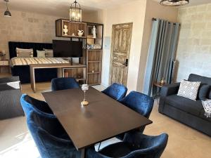 a living room with a table and blue chairs at Figata en ValQuirico in Santeagueda +23 photos