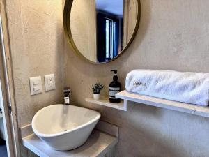 a bathroom with a white sink and a mirror at Venezia 2 en ValQuirico in Santeagueda