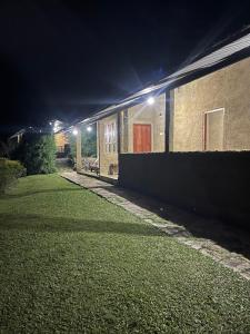 a brick building with a yard at night at Royal Mountain Edge ,Knuckles in Rangala