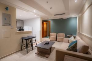 a living room with a couch and a table at بيت الضيافة in Jeddah