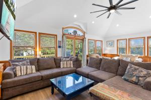 a living room with a couch and a table at 3057 - Olive the Beach in Southern Shores