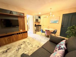 a living room with a couch and a flat screen tv at Mueganos 1 en ValQuirico in Santeagueda