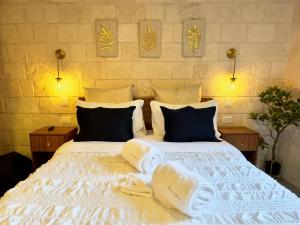 a bedroom with a white bed with towels on it at Mueganos 1 en ValQuirico in Santeagueda