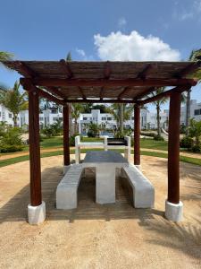 a picnic shelter with a bench in a park at Acapulco Diamante in Cedro
