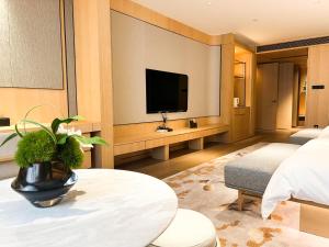 a hotel room with a television and a living room at 上海天平宾馆 in Shanghai