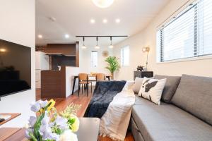a living room and kitchen with a couch and a table at tai南元町25 in Tokyo