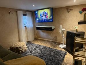 a living room with a flat screen tv on the wall at Loft Rafael en ValQuirico in Santeagueda