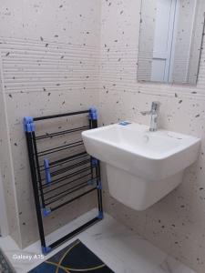 a bathroom with a white sink and a mirror at First MEN in Salalah