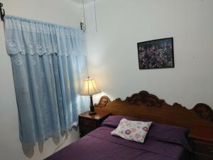 a bedroom with a bed and a lamp and a window at Connected House in Torreón in Torreón