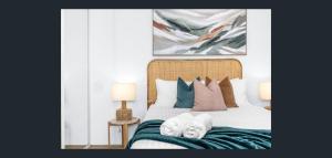 a bedroom with a bed with two towels on it at East Perth Apartment Suites with Parking in Perth