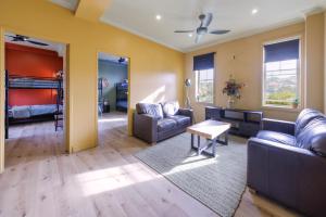 a living room with a couch and a bed at Mad Monkey Hostel Coogee Beach in Sydney