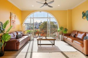 a living room with a couch and a table at Mad Monkey Hostel Coogee Beach in Sydney