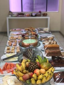 a table with a bunch of different types of food at Hotel Sabrina in Guanamby