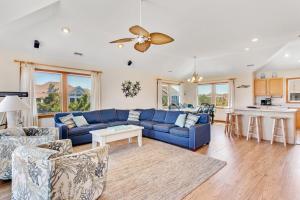 a living room with a blue couch and a table at 1700 - Carolina Delight in Poplar Branch