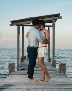a man and a woman standing on a pier at Ocean View PRIVATE BEACH in Cancún +57 photos