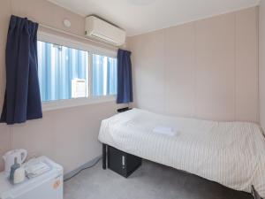 Postel nebo postele na pokoji v ubytování 住吉ビレッジ種子島