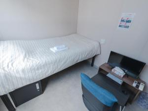 Postel nebo postele na pokoji v ubytování 住吉ビレッジ種子島