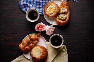 a table with two plates of pastries and two cups of coffee at Uwajima Oriental Hotel in Uwajima
