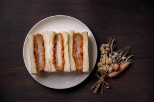 a white plate with a piece of bread on a table at Uwajima Oriental Hotel in Uwajima